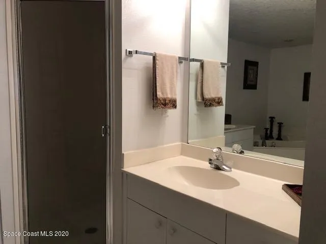 a bed sitting in a bedroom next to a lamp