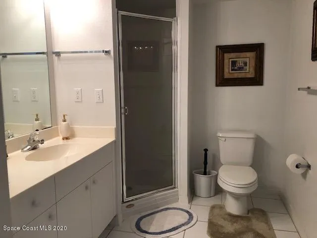 a bedroom with a bed and a potted plant