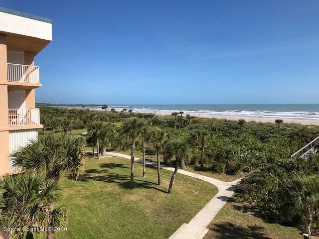 a view of a swimming pool with an outdoor seating and a yard