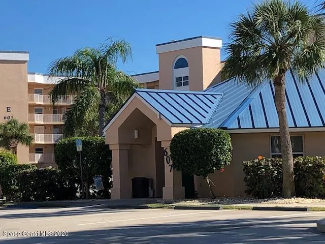 a view of a house with a yard in a backyard