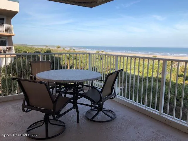 a view of a roof deck with furniture