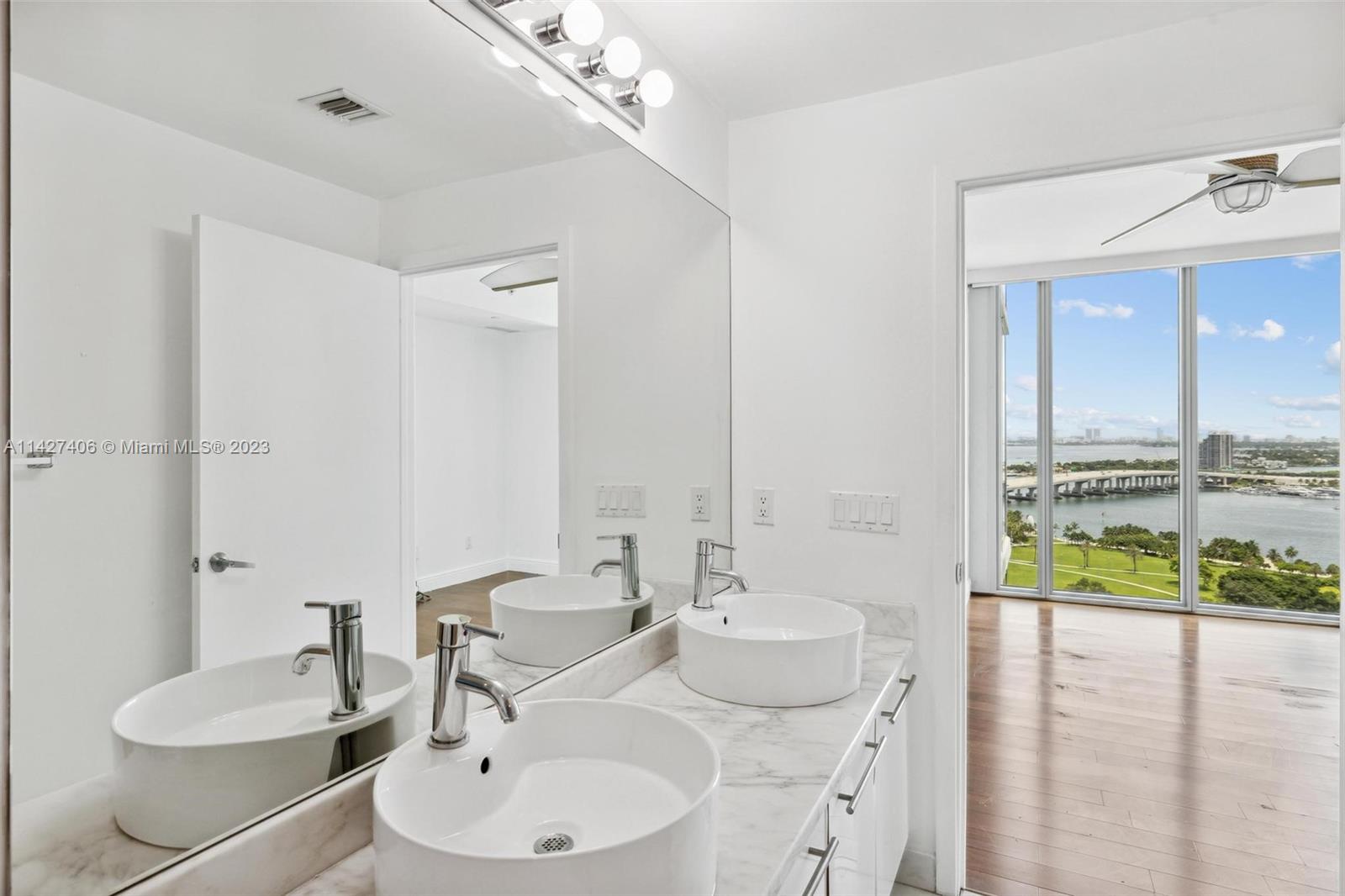 888 Biscayne Boulevard, Unit 2208 Miami, FL 33132 - Photo 12 of 20 a bathroom with a double vanity sink and a mirror