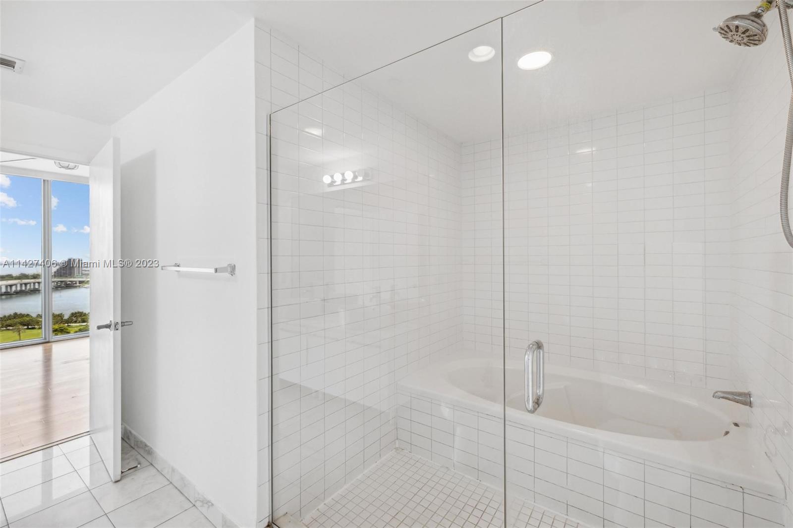 888 Biscayne Boulevard, Unit 2208 Miami, FL 33132 - Photo 13 of 20 a bathroom with a shower and a bath tub