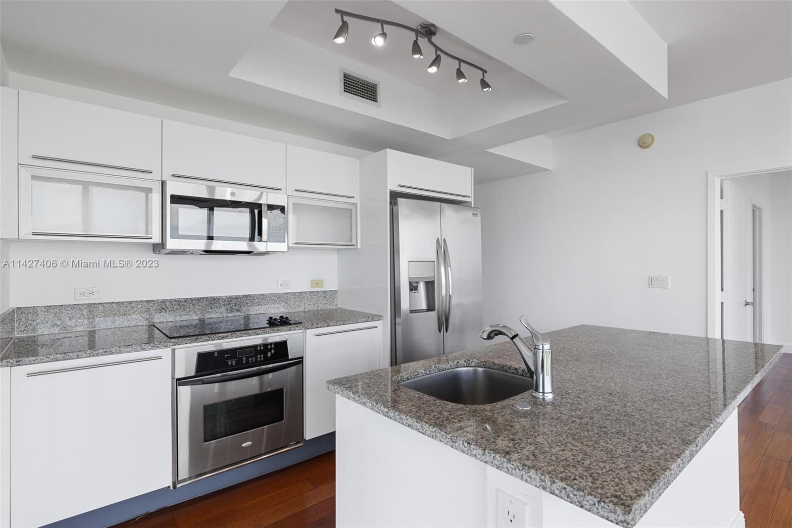 888 Biscayne Boulevard, Unit 2208 Miami, FL 33132 - Photo 5 of 20 a kitchen with stainless steel appliances granite countertop a sink stove and cabinets