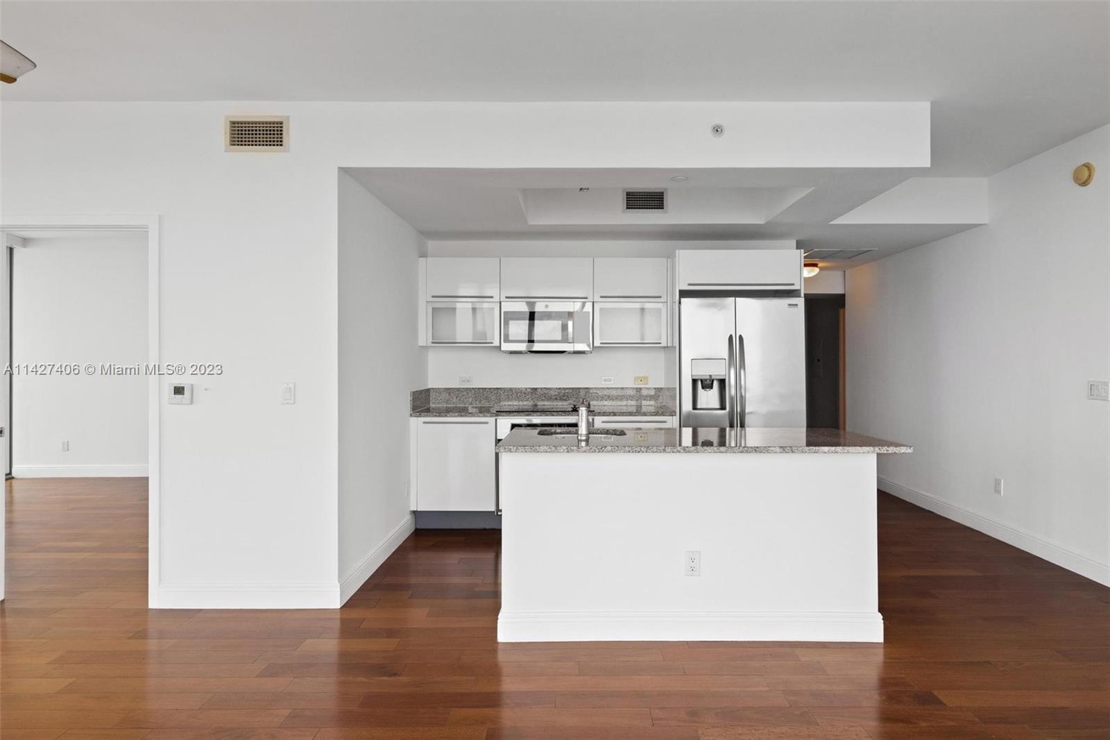 888 Biscayne Boulevard, Unit 2208 Miami, FL 33132 - Photo 7 of 20 a kitchen with a refrigerator and a stove top oven