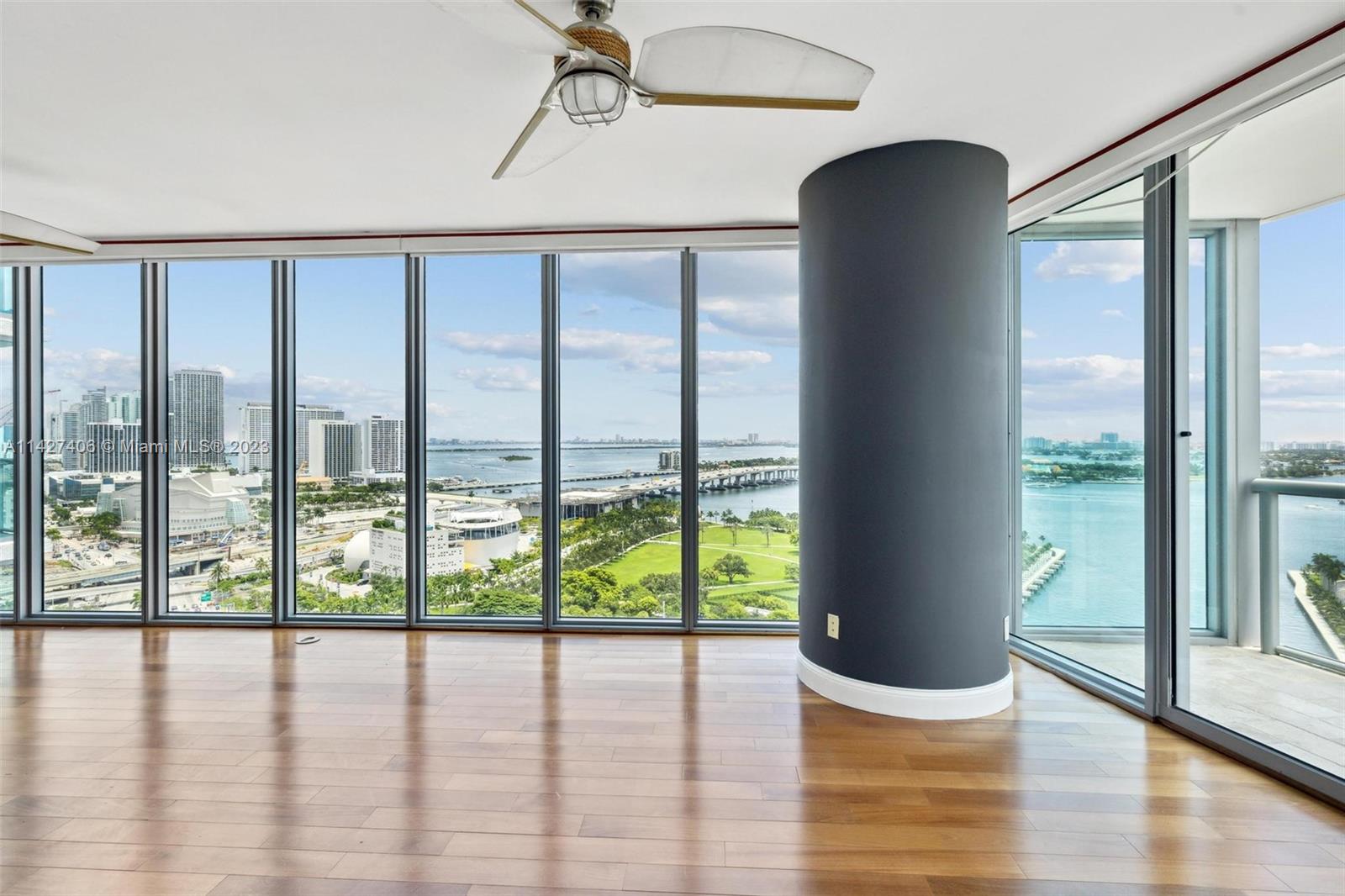 888 Biscayne Boulevard, Unit 2208 Miami, FL 33132 - Photo 8 of 20 a view of empty room with wooden floor and fan