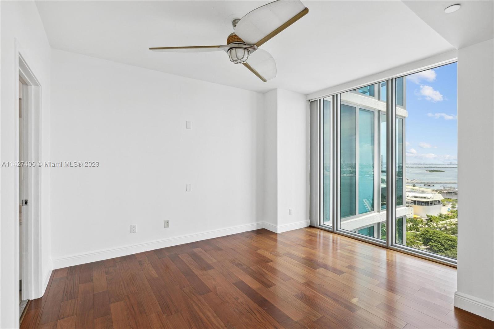 888 Biscayne Boulevard, Unit 2208 Miami, FL 33132 - Photo 10 of 20 a view of a room with wooden floor and windows