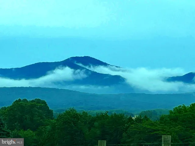 a kitchen with stainless steel appliances granite countertop a table chairs refrigerator and sink