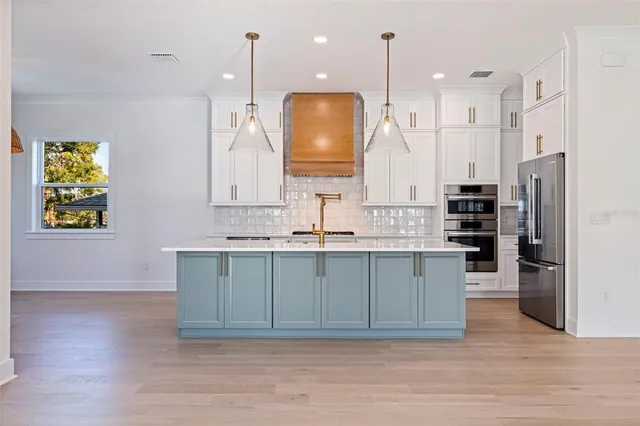 a bathroom with a sink a vanity a mirror and shower