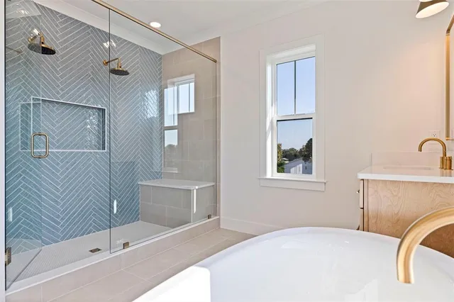 a bathroom with a tub sink and mirror