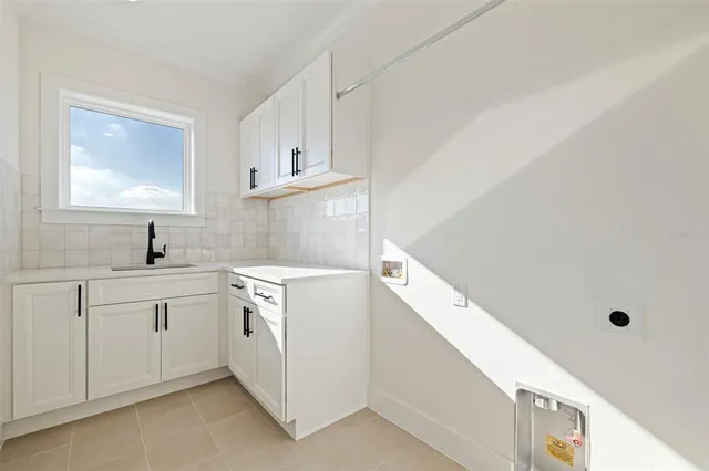 a kitchen with white cabinets and white appliances