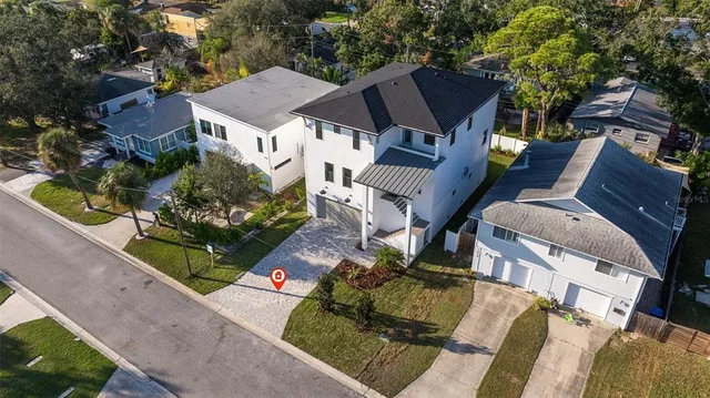 an aerial view of a house with a garden and lake view