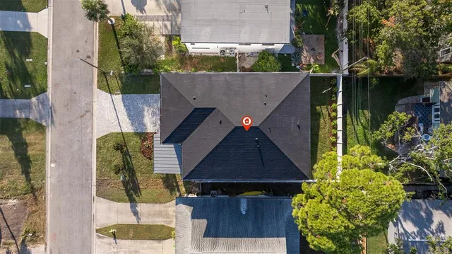 a aerial view of a house with table and chairs potted plants