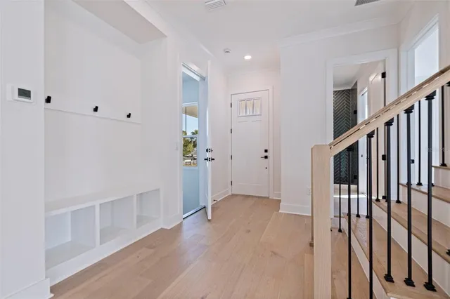 a view of an entryway with wooden floor