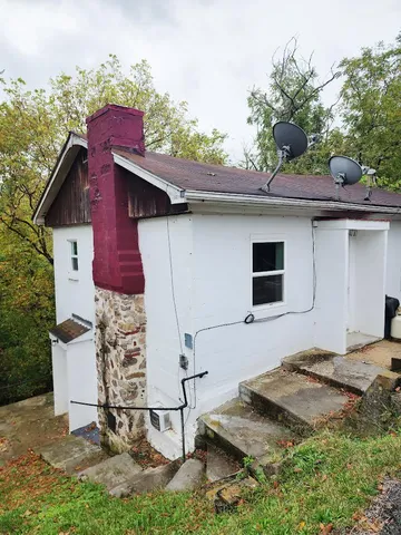 a backyard of a house with table and chairs