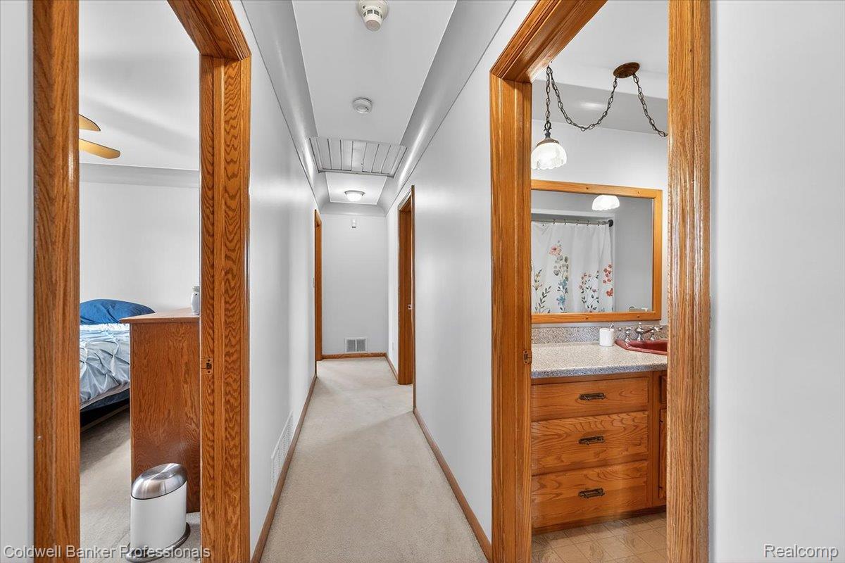 7410 Wilson Road Montrose, MI 48457 - Photo 23 of 38 Hallway featuring light colored carpet and baseboards
