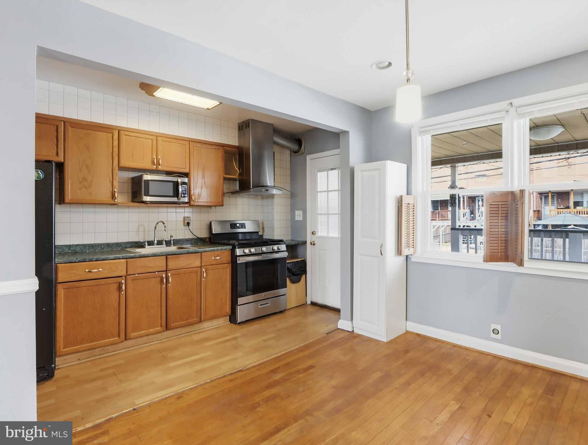 6832 Broening Road Baltimore, MD 21222 - Photo 13 of 34 a kitchen with granite countertop a refrigerator stove top oven and sink