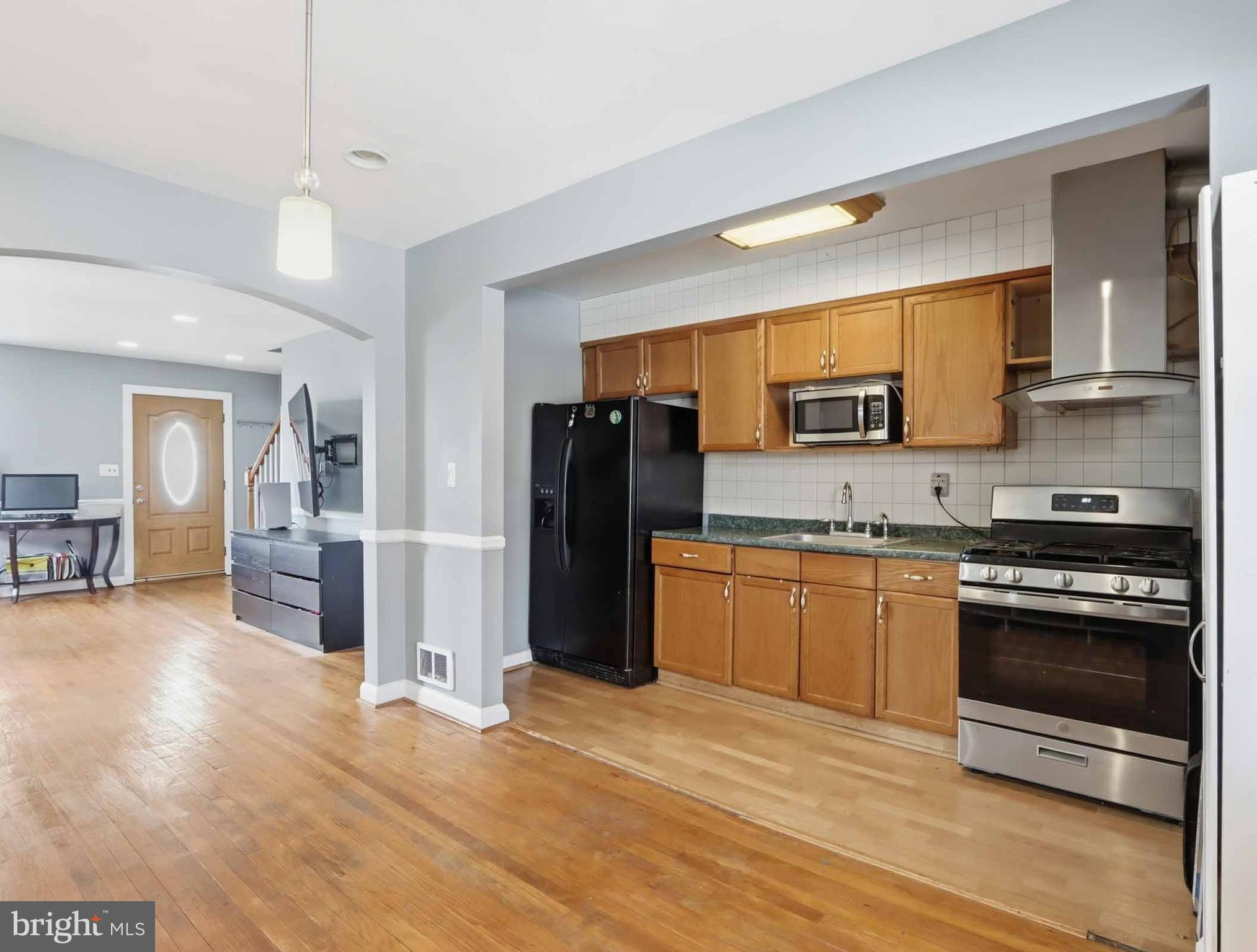 6832 Broening Road Baltimore, MD 21222 - Photo 14 of 34 a kitchen with granite countertop stainless steel appliances and wooden cabinets