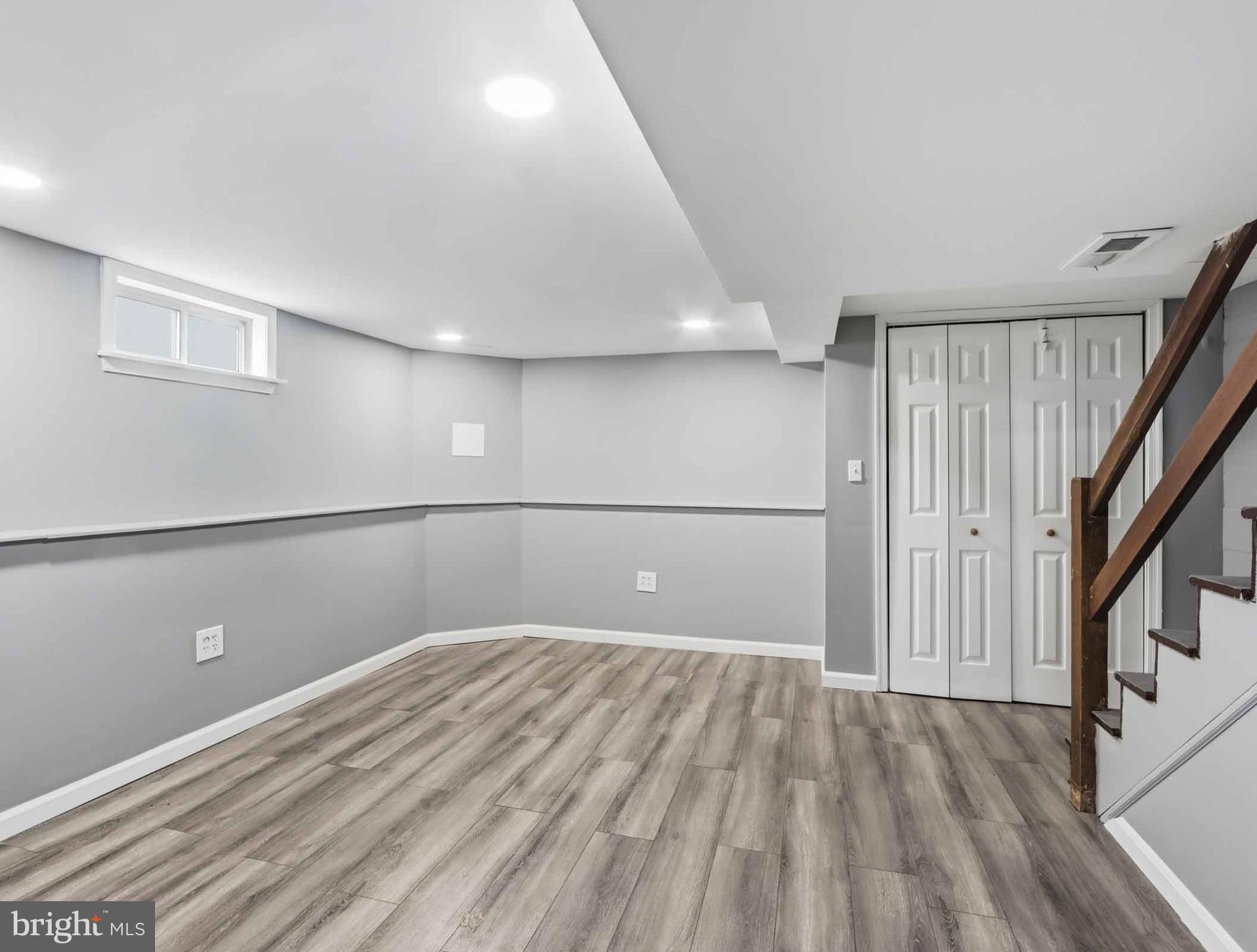 6832 Broening Road Baltimore, MD 21222 - Photo 19 of 34 a view of a big room with wooden floor and staircase