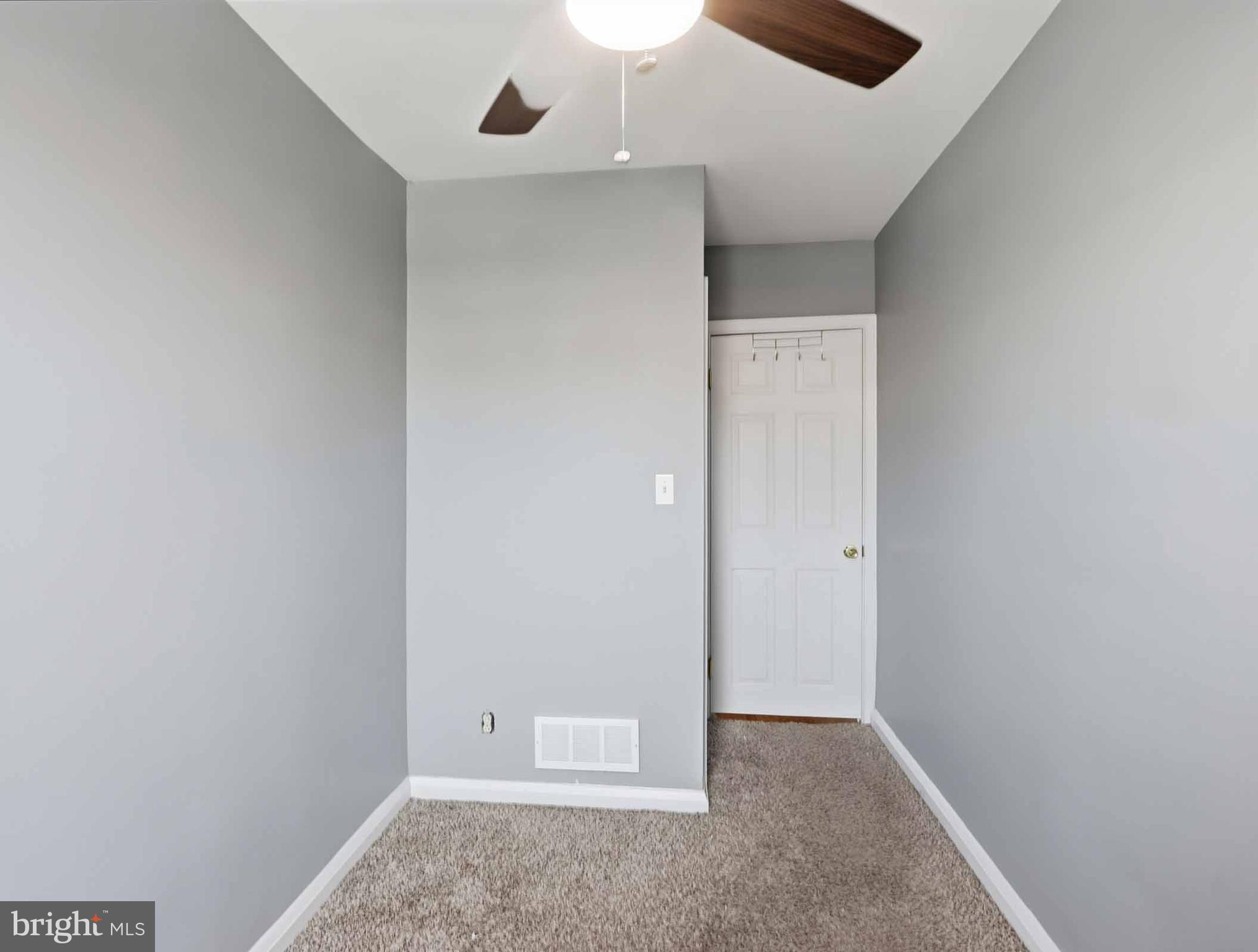 6832 Broening Road Baltimore, MD 21222 - Photo 26 of 34 an empty room with closet and a chandelier fan
