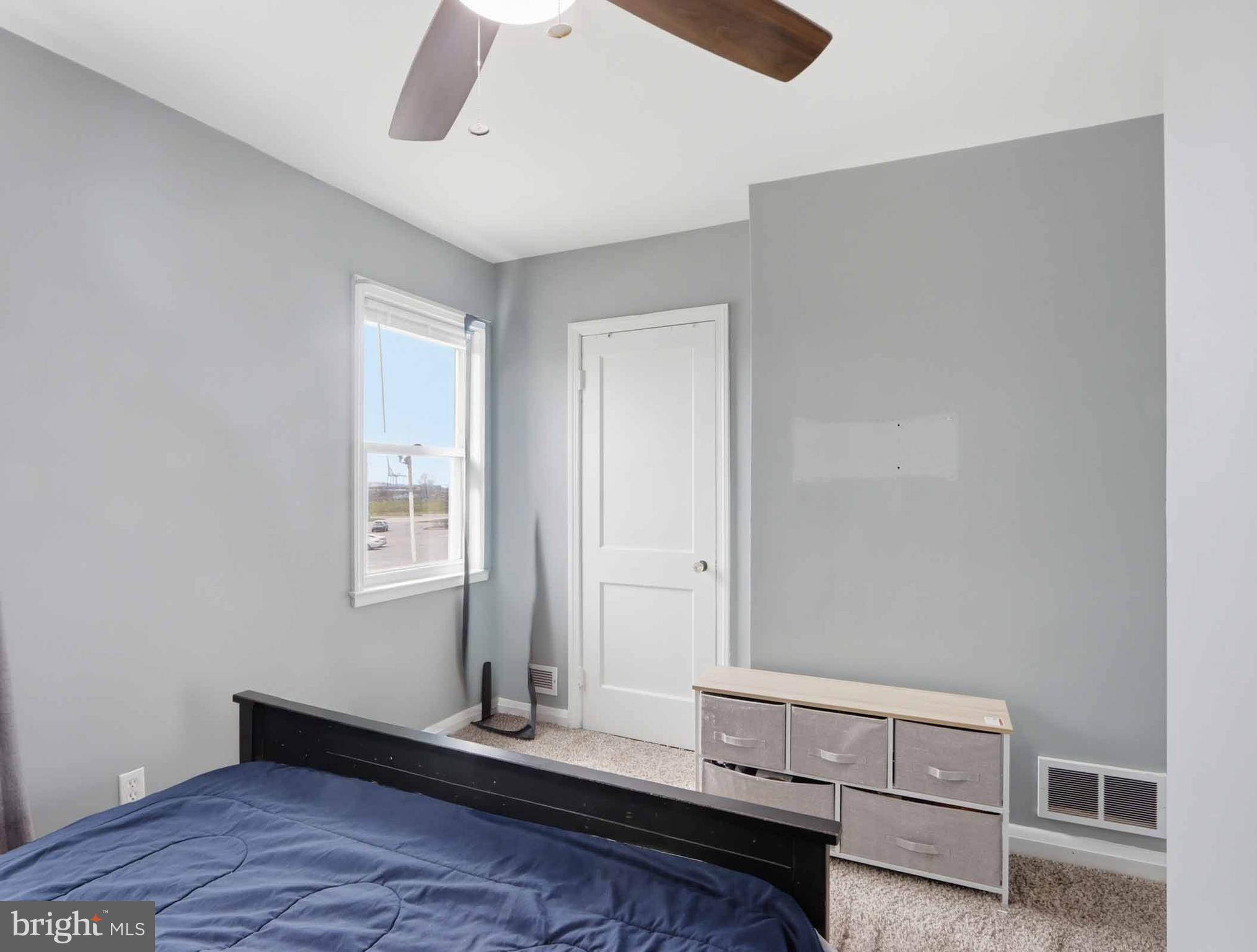 6832 Broening Road Baltimore, MD 21222 - Photo 32 of 34 a room with a bed and a window