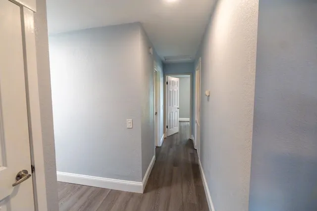 a view of a hallway with seating area and appliances