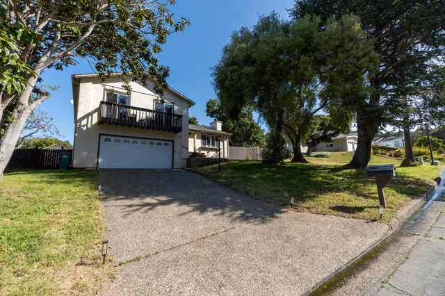 a front view of a house with a yard garage and outdoor seating