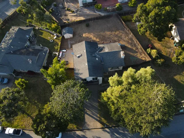 an aerial view of a house with a yard and a garden