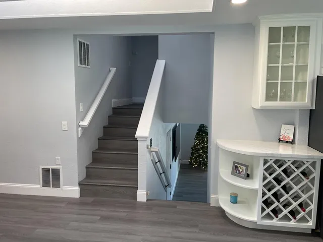 a view of a house with a yard and a large parking space