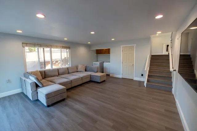 an ocean view with beach and trees in the background