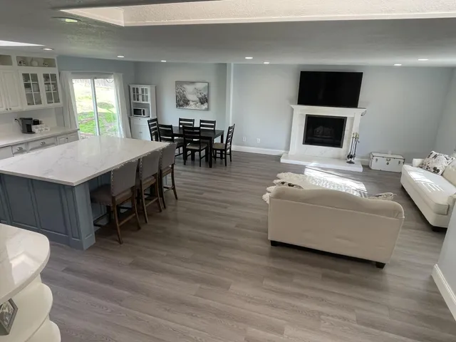 a living room with furniture a flat screen tv and a fireplace