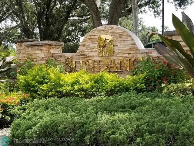 a view of fountain with a tree in the background