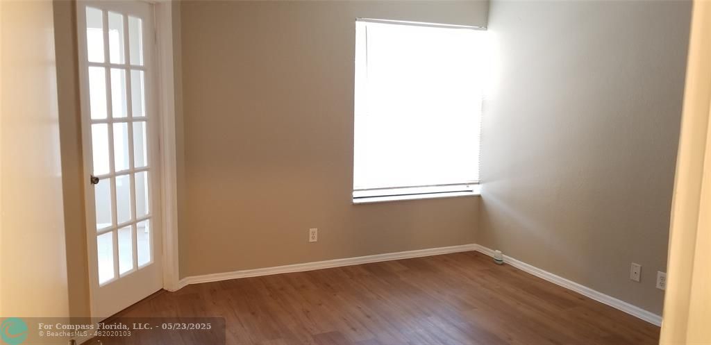 2846 South University Drive, Unit 4205 Davie, FL 33328 - Photo 8 of 9 an empty room with wooden floor and windows