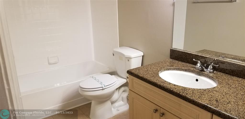 2846 South University Drive, Unit 4205 Davie, FL 33328 - Photo 9 of 9 a bathroom with a granite countertop sink and a mirror