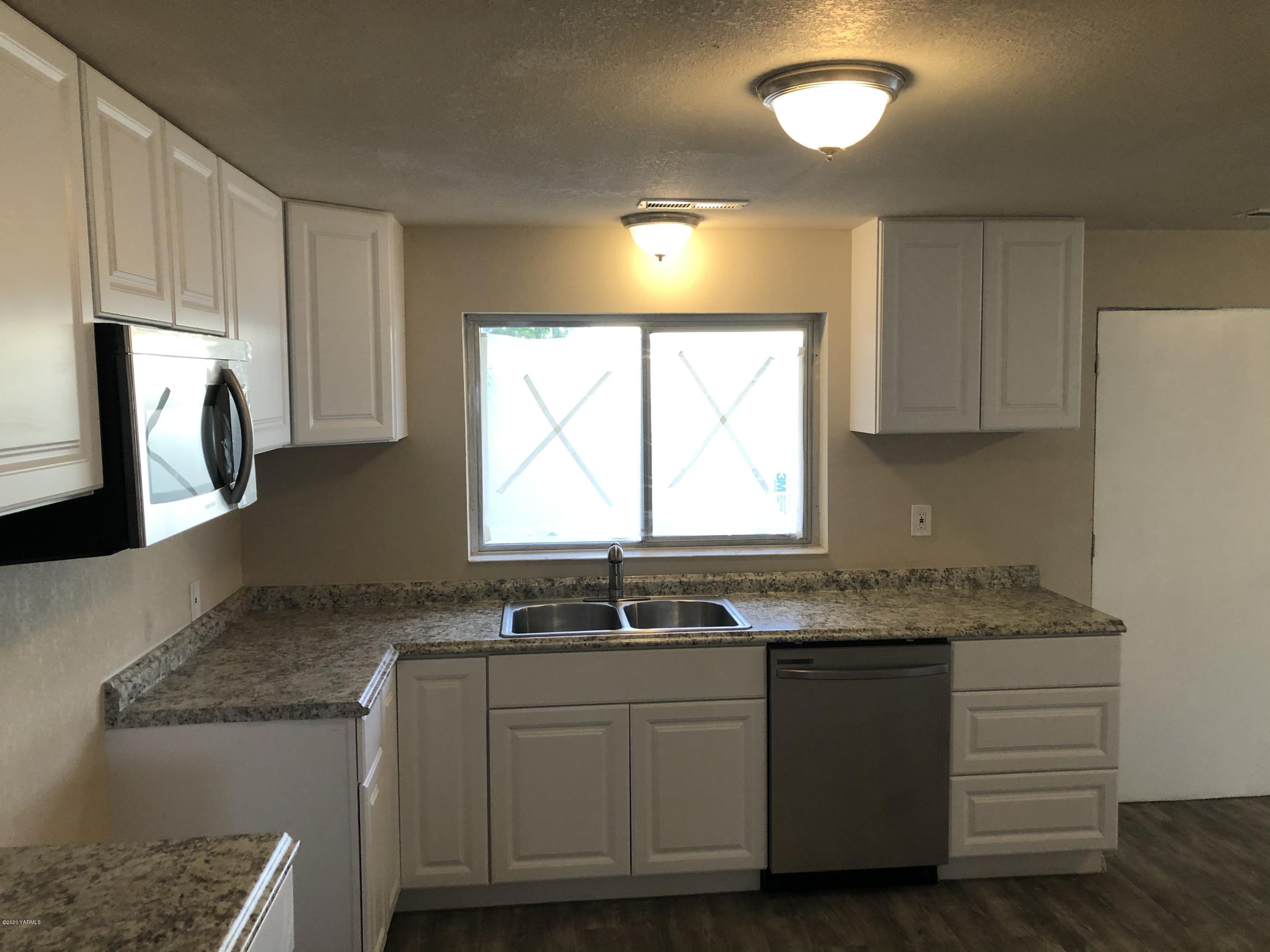 4950 Lateral A Road Wapato, WA 98951 - Photo 15 of 31 a kitchen with granite countertop a sink window and cabinets