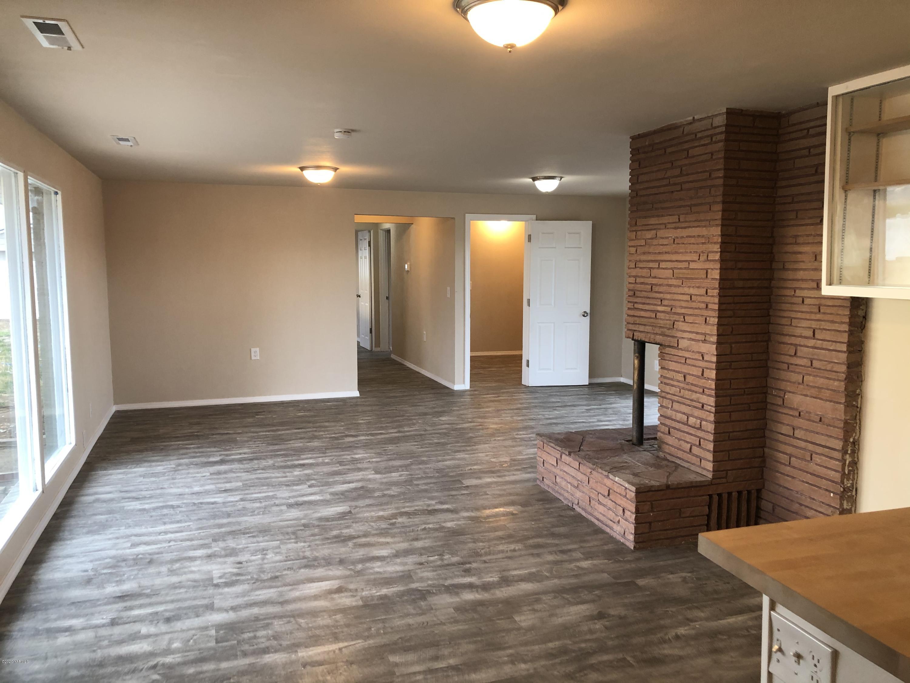 4950 Lateral A Road Wapato, WA 98951 - Photo 18 of 31 a view of a hallway with wooden floor and staircase