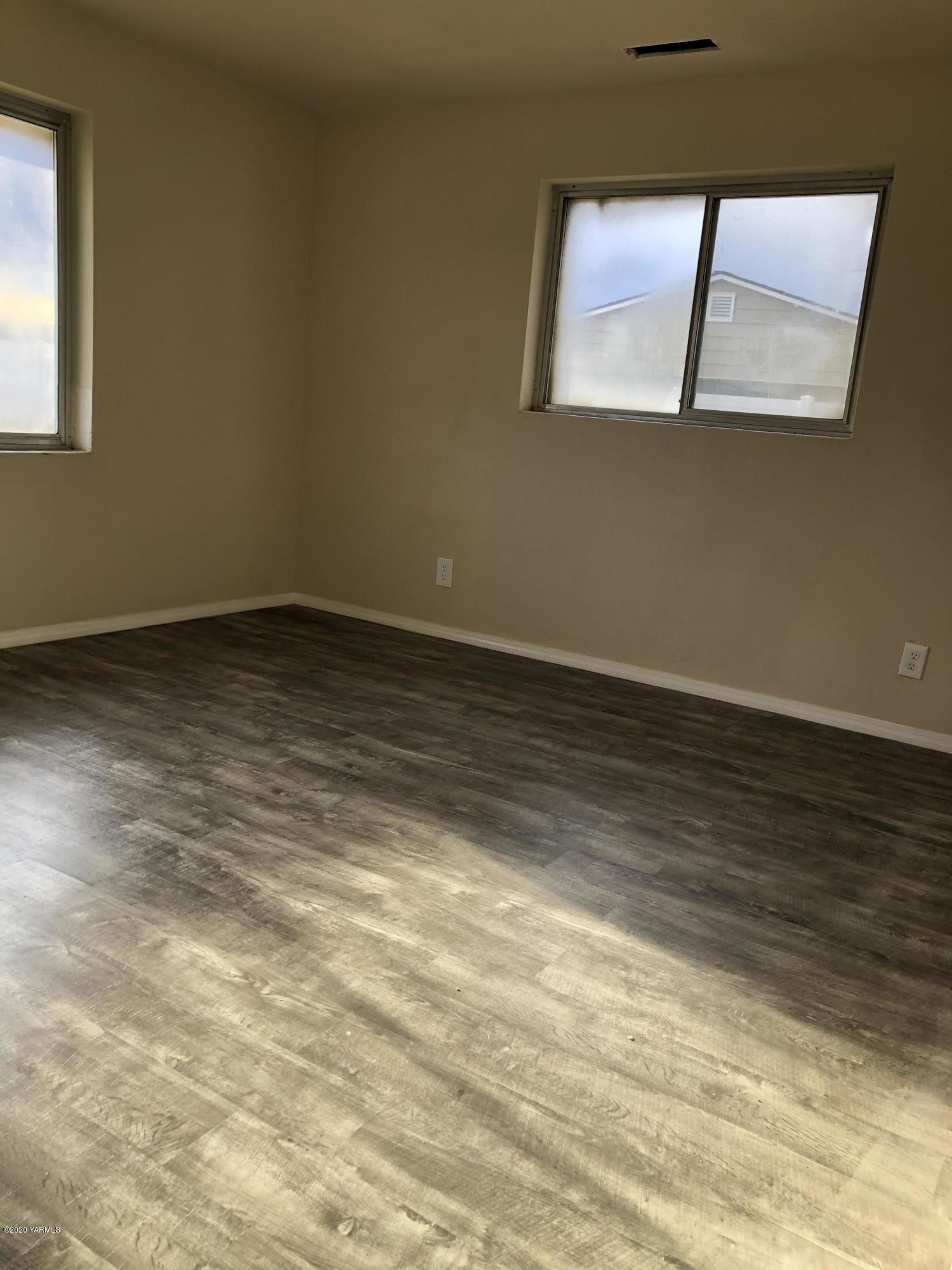 4950 Lateral A Road Wapato, WA 98951 - Photo 19 of 31 a view of an empty room with wooden floor and a window