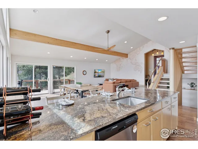 a kitchen with counter top space and living room