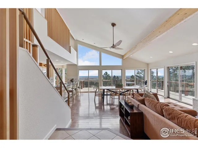 a living room with lots of furniture and a large window
