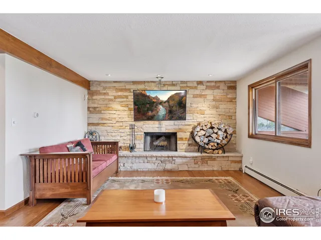 a living room with furniture a fireplace and a rug