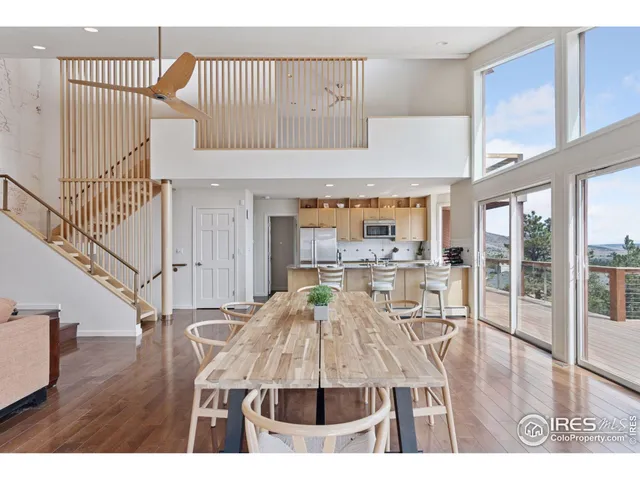 a dining room with furniture a chandelier and wooden floor