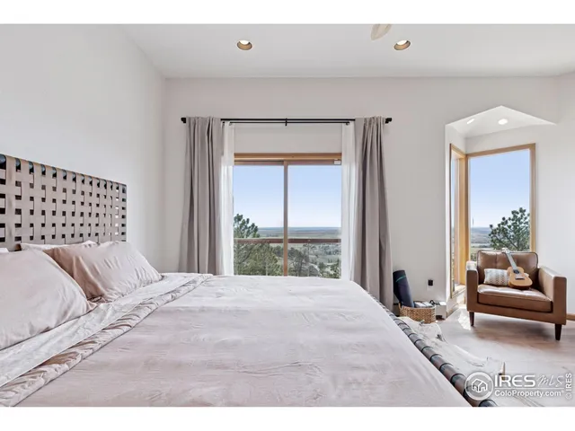 a bedroom with a large bed and a large window