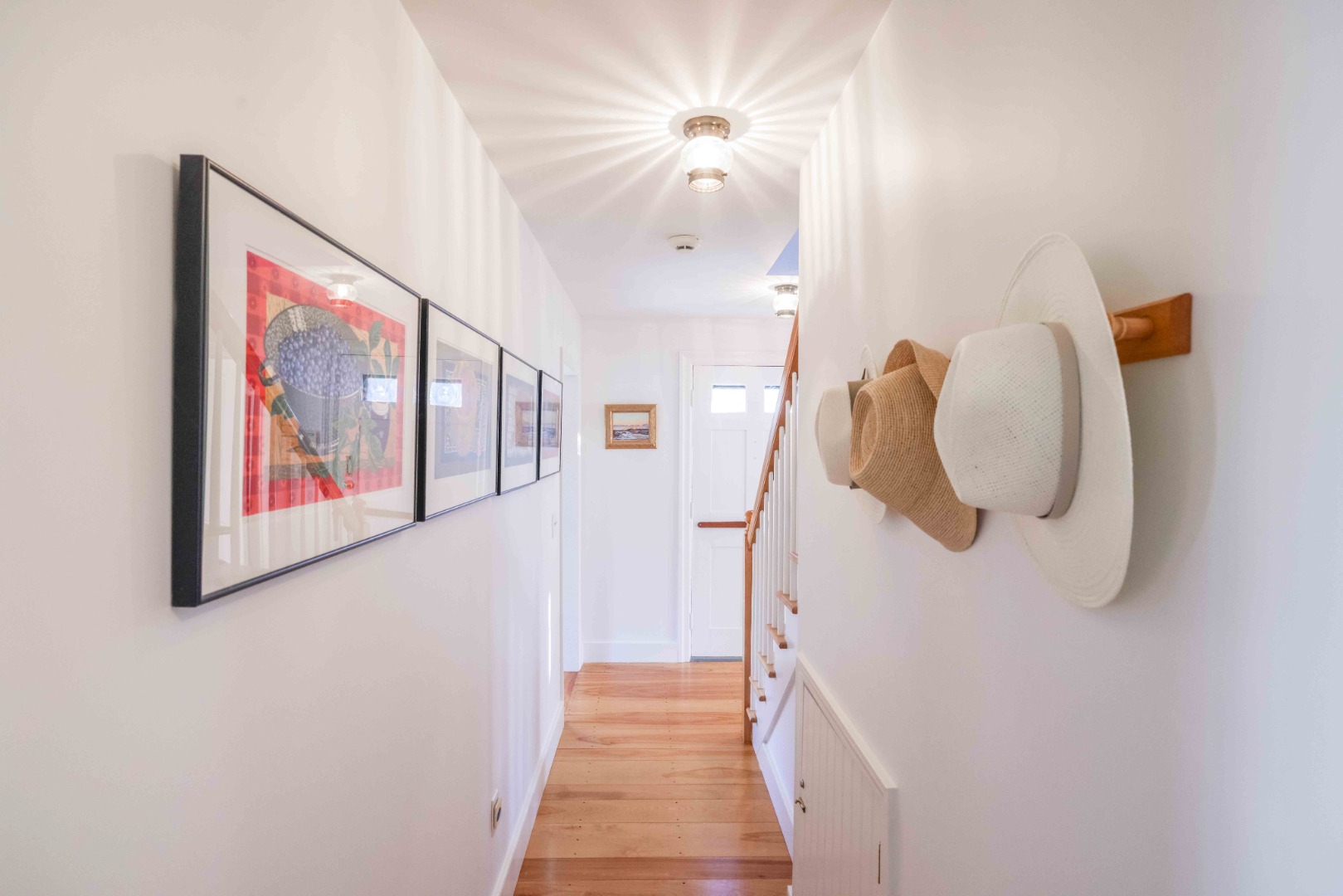 13 West Chester Street Nantucket, MA 02554 - Photo 30 of 32 a view of a hallway with paintings on the wall