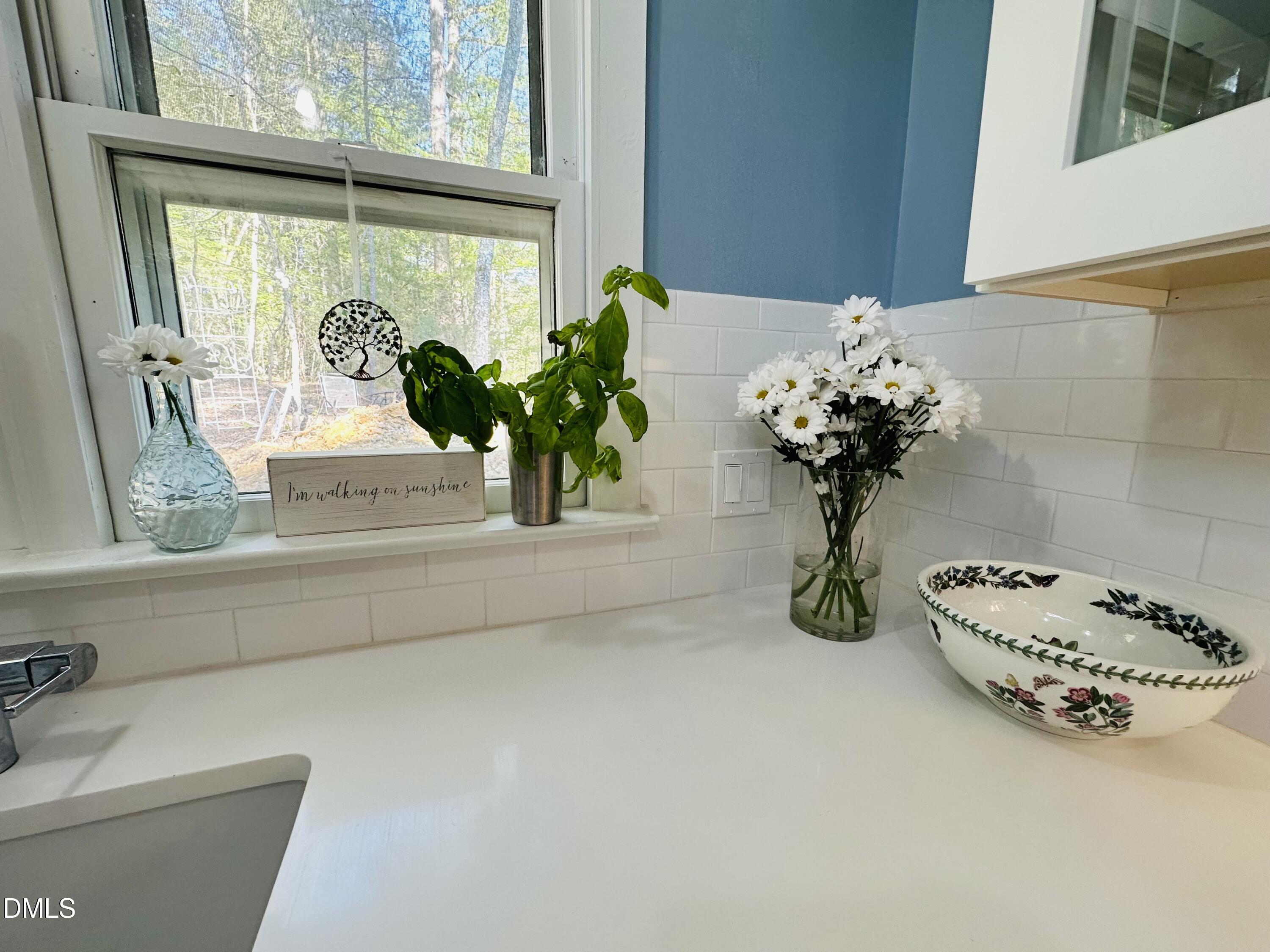 6202 Montgomery Ests Road Hillsborough, NC 27278 - Photo 17 of 91 a vase of flowers sitting on a floor next to a window