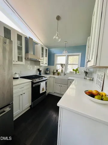 a view of a room with furniture and a floor to ceiling window