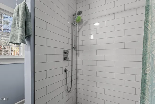 a living room with stainless steel appliances kitchen island granite countertop a sink a stove and large window