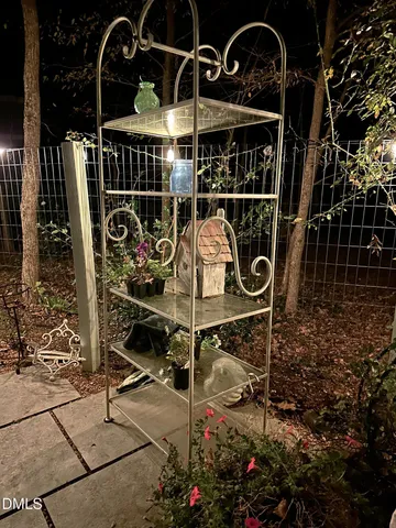 a view of a fire pit with large trees