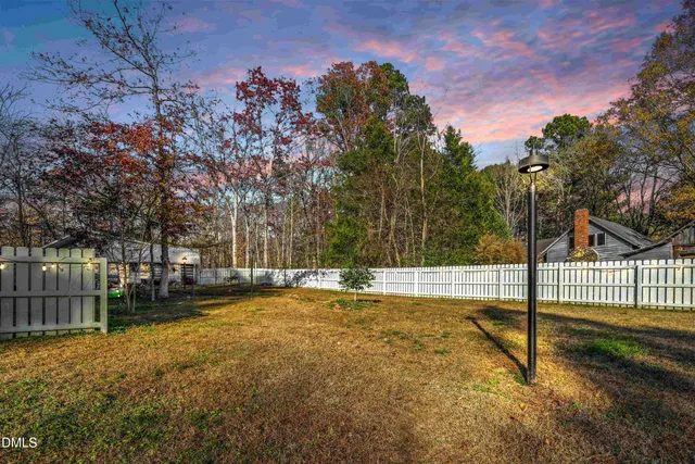 a view of a yard with a tree
