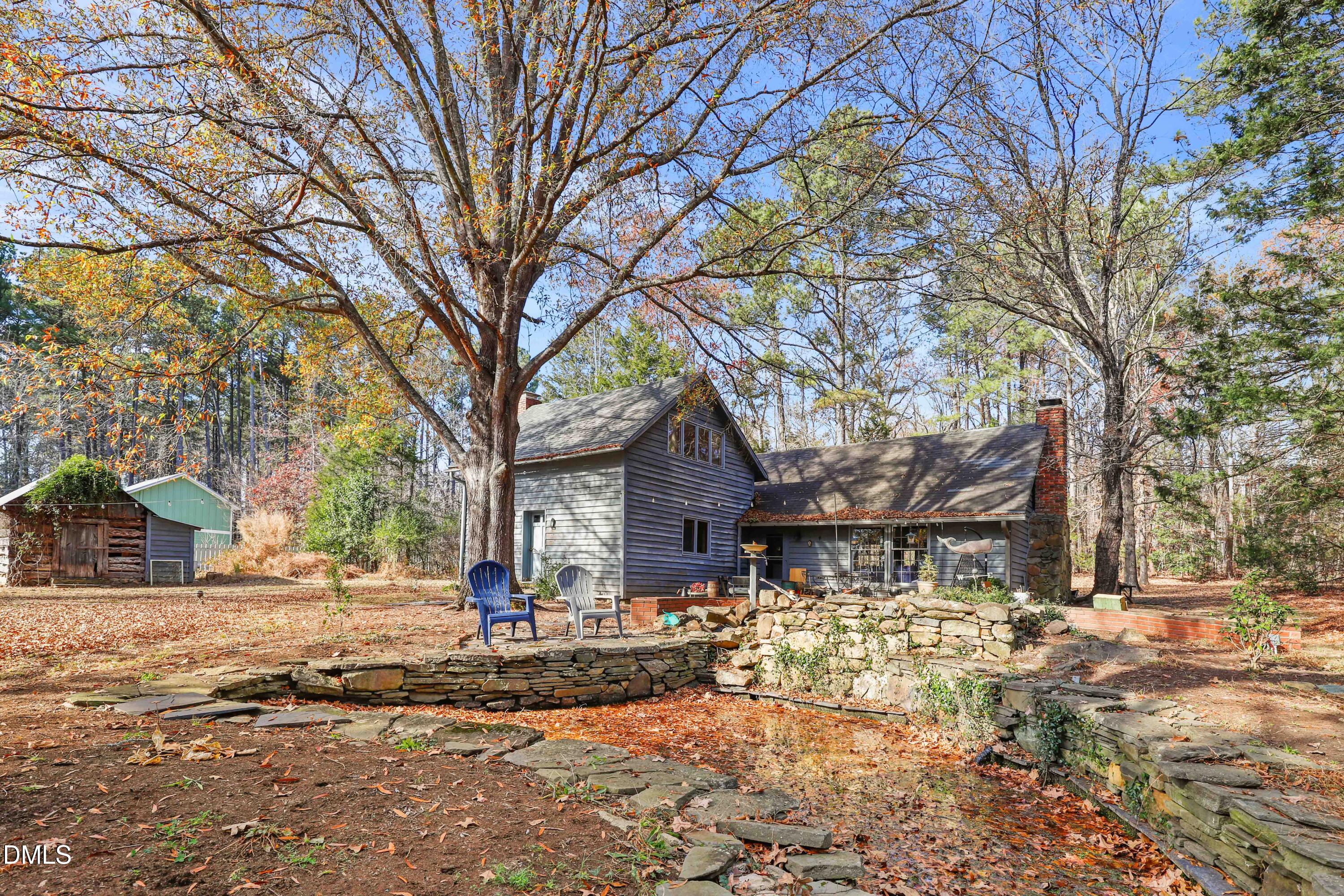 6202 Montgomery Ests Road Hillsborough, NC 27278 - Photo 36 of 91 a front view of a house with a yard covered with snow and trees