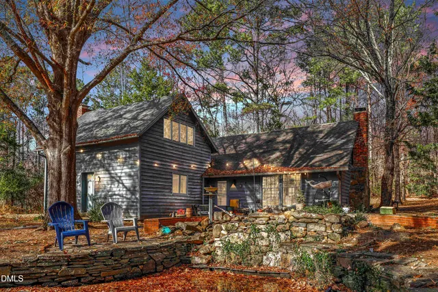 a bed room with a bed a couch and a window